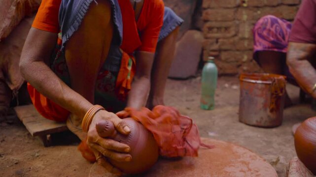 Indian woman painting ceramic pot at Dharavi, Mumbai, India