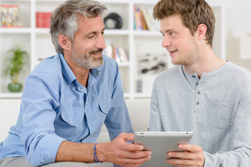 father and son using a tablet