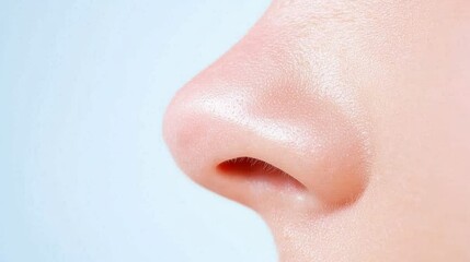 Elegant closeup, exploring the subtle beauty of a woman's nose against pristine white background