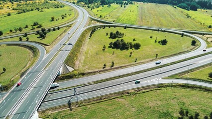 Cars driving on road next to forest
