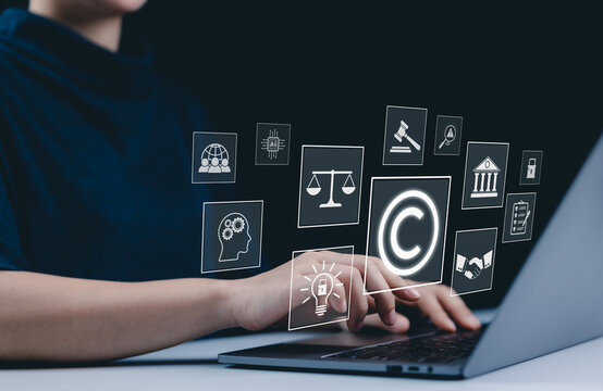 Copyright and intellectual property protection concept. A person use laptop with icons copyright, intellectual property, legal balance scales, patents, technology law, digital rights, and protection.