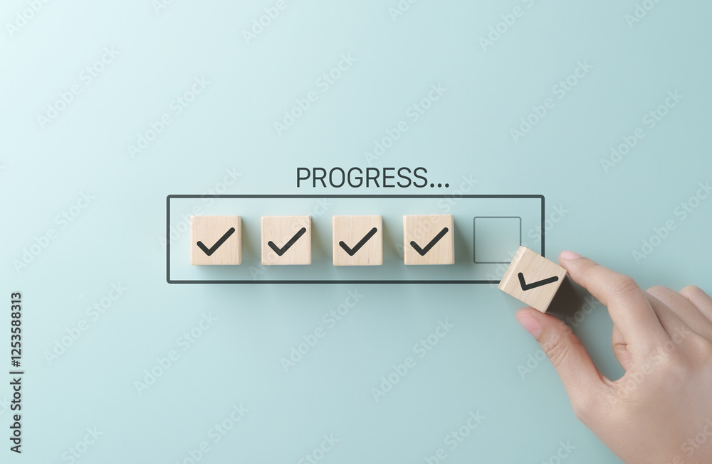 Poster Checklist and task progress tracking concept. A hand placing the final checkmark on wooden blocks in a progress bar, task completion, productivity, goal setting, and efficient project management.