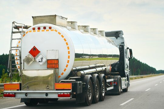 Truck hauling hazardous liquid cargo down road