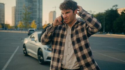 Worried stressed man driver Caucasian guy talk mobile phone calling car service engine problem stand on road outdoors broken car background vehicle breakdown damaged automobile wreck need help in city