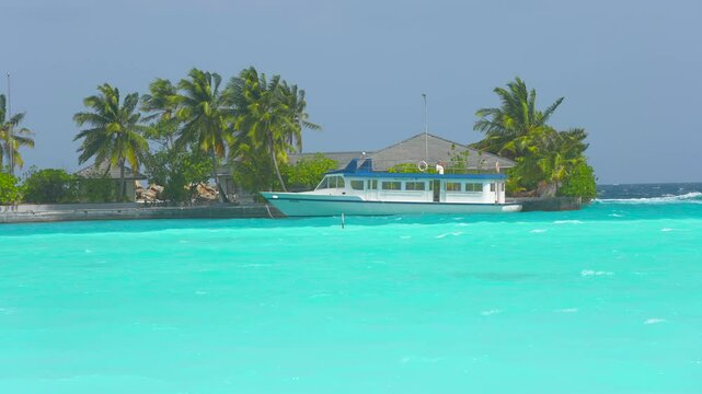 Aerial drone video of tropical paradise exotic island bay covered in limestone trees with emerald crystal clear beach visited by luxury yachts and sail boats in Caribbean destination