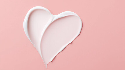 White cosmetic cream forming heart shape on pink background