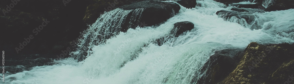 Poster halftone texture of cascading waterfall over rugged rocks with grunge effects