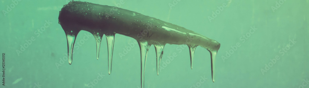 Aufkleber Halftone texture of a sharp icicle with dripping end against a grunge background