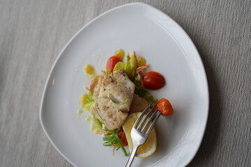 Gourmet Salmon Dish with Vegetables and Lemon