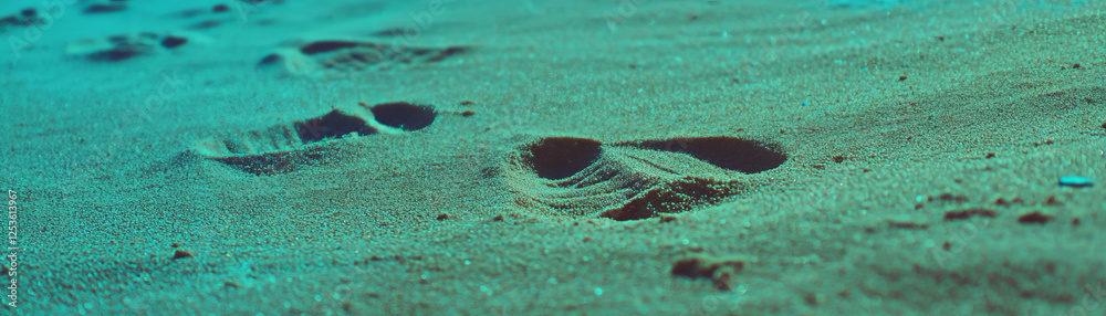 Poster footprints in sand revealing depth and shape under halftone texture effect