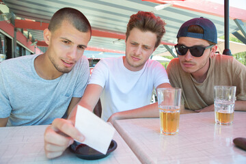 three men having a drink outdoors