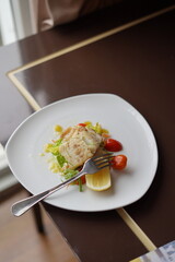 Plated Salmon Seafood Dish with Lemon and Salad