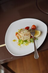 Plated Salmon Seafood Dish with Lemon and Salad