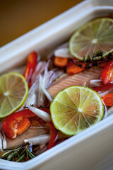 Fish fillets and ingredients in a porcelain plate