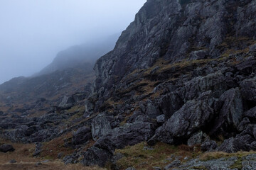 Rock on mountainside in Moelwyn range in misty weather