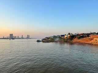 Boats moored at the banks of the Mekong river near the city of Phnom Penh in Cambodia