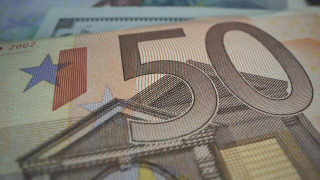 Euro banknotes of different denominations during counting in the counting machine. The currency of the European Union. Close-up