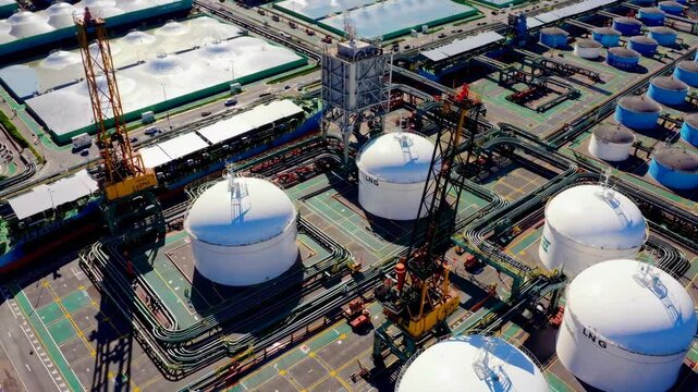 liquefied natural gas (LNG) terminal with massive storage tanks and ships docked