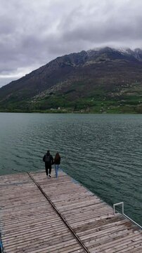 Scenic Drone Shot of Couple on Dock at Plav Lake