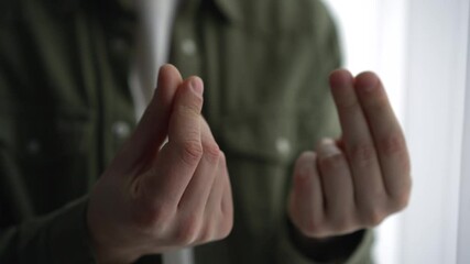A man shows with his hands that he needs money.
A man demands a salary increase.
Businessman showing finance and money gesture