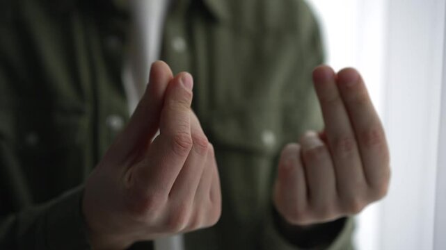 A man shows with his hands that he needs money.
A man demands a salary increase.
Businessman showing finance and money gesture