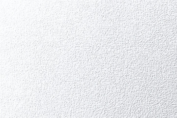 Textured white surface, close-up view, rough stucco wall, minimalist background, monochromatic, subtle shadows, granular detail, abstract pattern, matte finish, clean aesthetic, high contrast, stark 