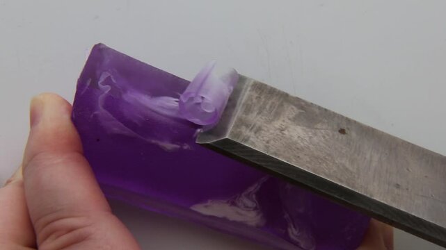 Purple soap being sliced with a straight-edge tool, showcasing clean cuts and a satisfying tactile motion. Perfect for ASMR and creative relaxation.