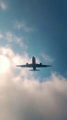 Obraz premium Airplane in the sky, bottom view, flying through clouds, dramatic aviation landscape, mystical atmosphere, light through clouds, airplane in clouds, aviation, sky journey, air travel.