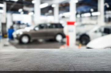 steel desk and car service station background