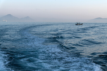 Obraz premium fishing boat with fog on the sea at dawn