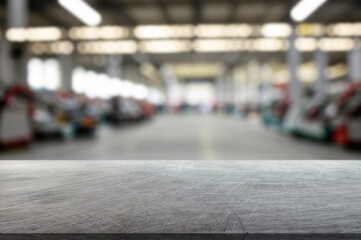 blurred background of factory and empty steel tabletop in foreground. Business presentation