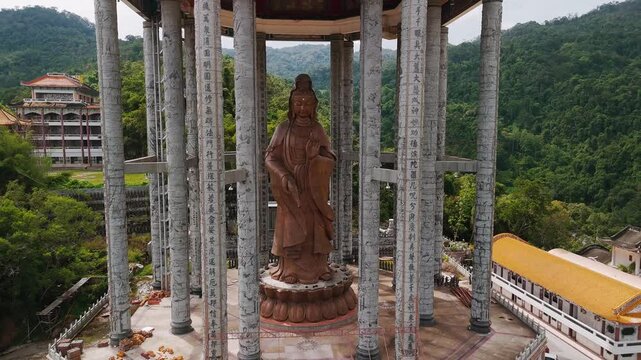 Penang landmark kek lok si temple highlighting massive bronze kuan yin statue, symbolizing divine compassion amid intricate architectural details