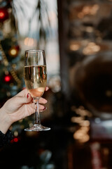 Woman hand holding champagne glass 