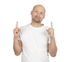 Man in a white t-shirt pointing upwards with a thoughtful smile