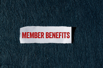 Member benefits message written on ripped torn paper piece with gray background. Conceptual member benefits symbol. Copy space.