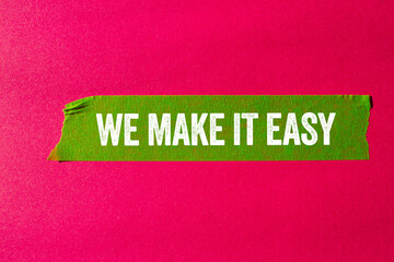 We make it easy message written on ripped torn green paper tape on pink background. Conceptual we make it easy symbol. Copy space.