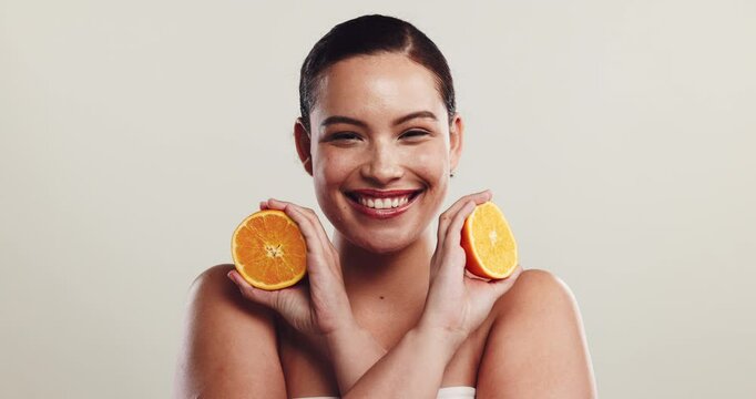 Girl, orange or face in studio for skincare, natural treatment or vitamin C. Happy woman, citrus fruit or relax on white background space for organic care, healthy skin or hydration with antioxidants