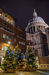 Obraz premium Festive Christmas Trees Illuminated at Night Near St. Paul’s Cathedral, London