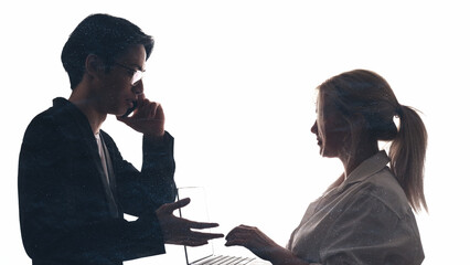 Obraz premium Business team. Colleagues silhouette. Corporate assistance. Dark profile outline of people working using laptop speaking on phone isolated on white copy space background.