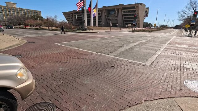 footage of Dallas City Hall with flags flying and trees in downtown Dallas Texas USA