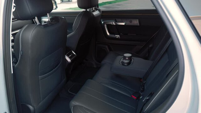 view of the rear black color leather seats of the SUV no people. 