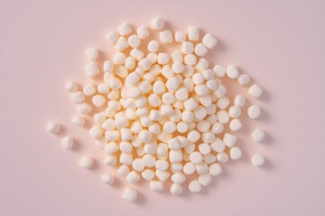A pile of white marshmallows on a pink surface, great for food and dessert photography