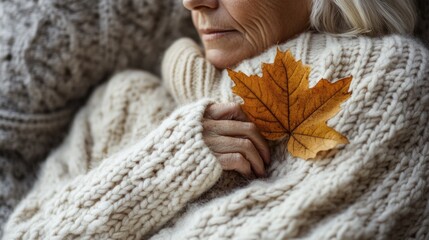 A person holds a leaf in their hands, possibly symbolizing new life or nature connection