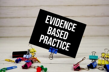 Evidence Based Pratice text on paper card with stationary on wooden background