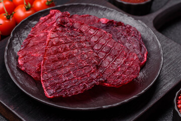 Dried beef slices, jerky, with cherry or plum flavor, salt and spices