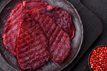 Dried beef slices, jerky, with cherry or plum flavor, salt and spices