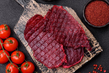 Dried beef slices, jerky, with cherry or plum flavor, salt and spices