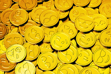Gold souvenircoins with various faces. World Emoji Day Concept