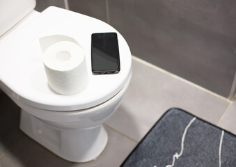 Smartphone and Toilet Paper on Toilet Seat Digital Dependency Concept