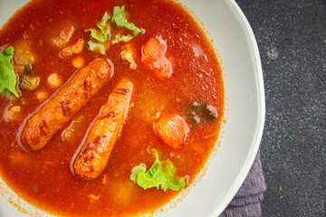 Tomato soup with sausages fresh tasty food dish delicious gourmet food background on the table rustic food top view copy space